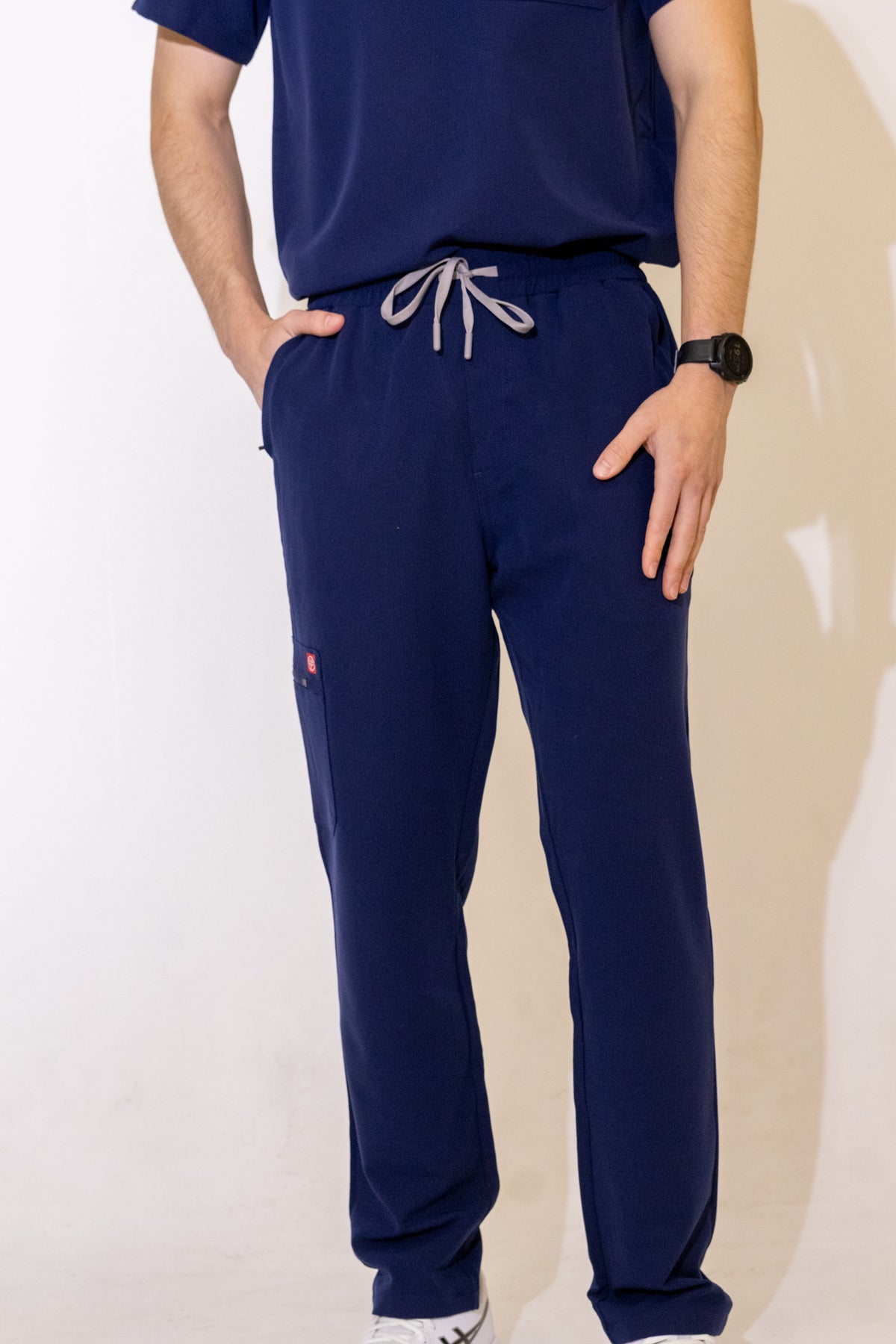 PAX Core Sequi men's navy straight-leg scrub trousers, front view showing the drawstring waist and straight-leg fit