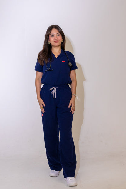 PAX Core Luma women's navy wide-leg scrub set, full-length front view with the top tucked in