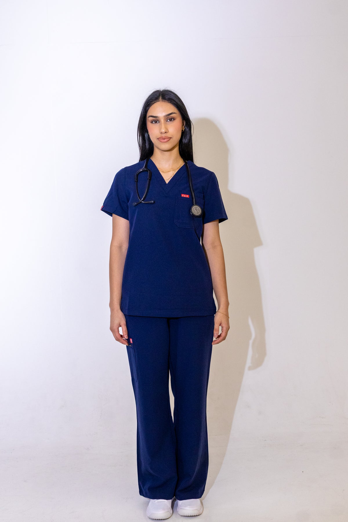 PAX Core Luma women's navy wide-leg scrub trousers, full-length front view with the matching top