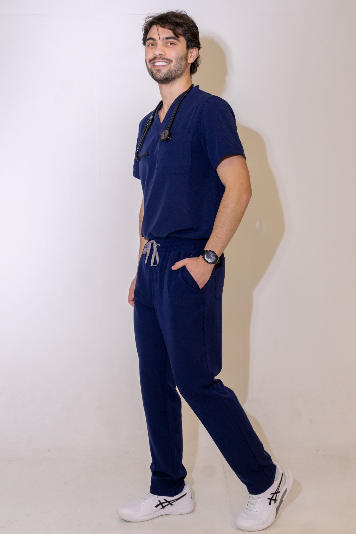 PAX Core Sequi men's navy straight-leg scrub trousers, full-length three-quarter view with the matching top