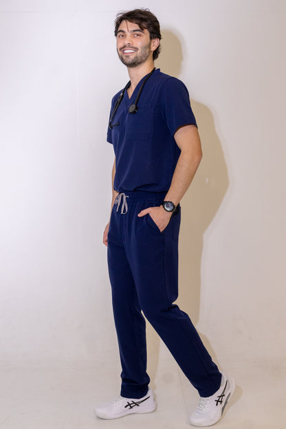 PAX Core Sequi men's navy straight-leg scrub set, full-length three-quarter view in movement