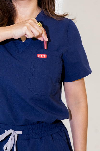 PAX Core Luma women's navy wide-leg scrub set, chest pocket and pen slot detail