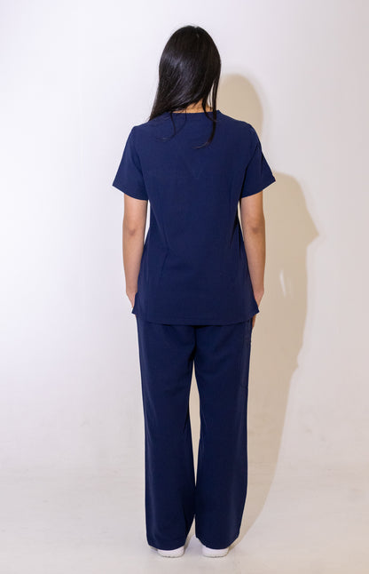 PAX Core Luma women's navy wide-leg scrub trousers, full-length back view with the matching top