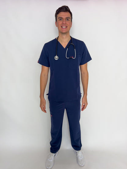 Front view of a doctor with a stethoscope in a fitted royal blue PAX scrub set.