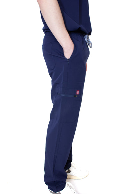 Side view of a doctor wearing PAX scrubs, focusing on the right-sided cargo pocket with the PAX logo, paired with white sneakers.