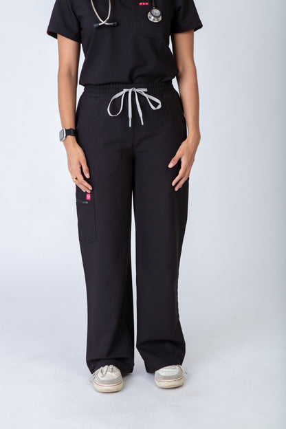 Person wearing black scrubs with white drawstrings on a white background