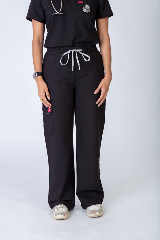 Person wearing black scrubs with white drawstrings on a white background