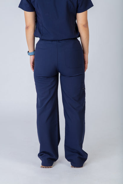 Person wearing navy blue scrubs on a plain background