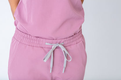 Pink outfit with a drawstring on a plain background