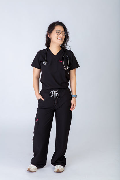 Person wearing black medical scrubs with a stethoscope on a white background