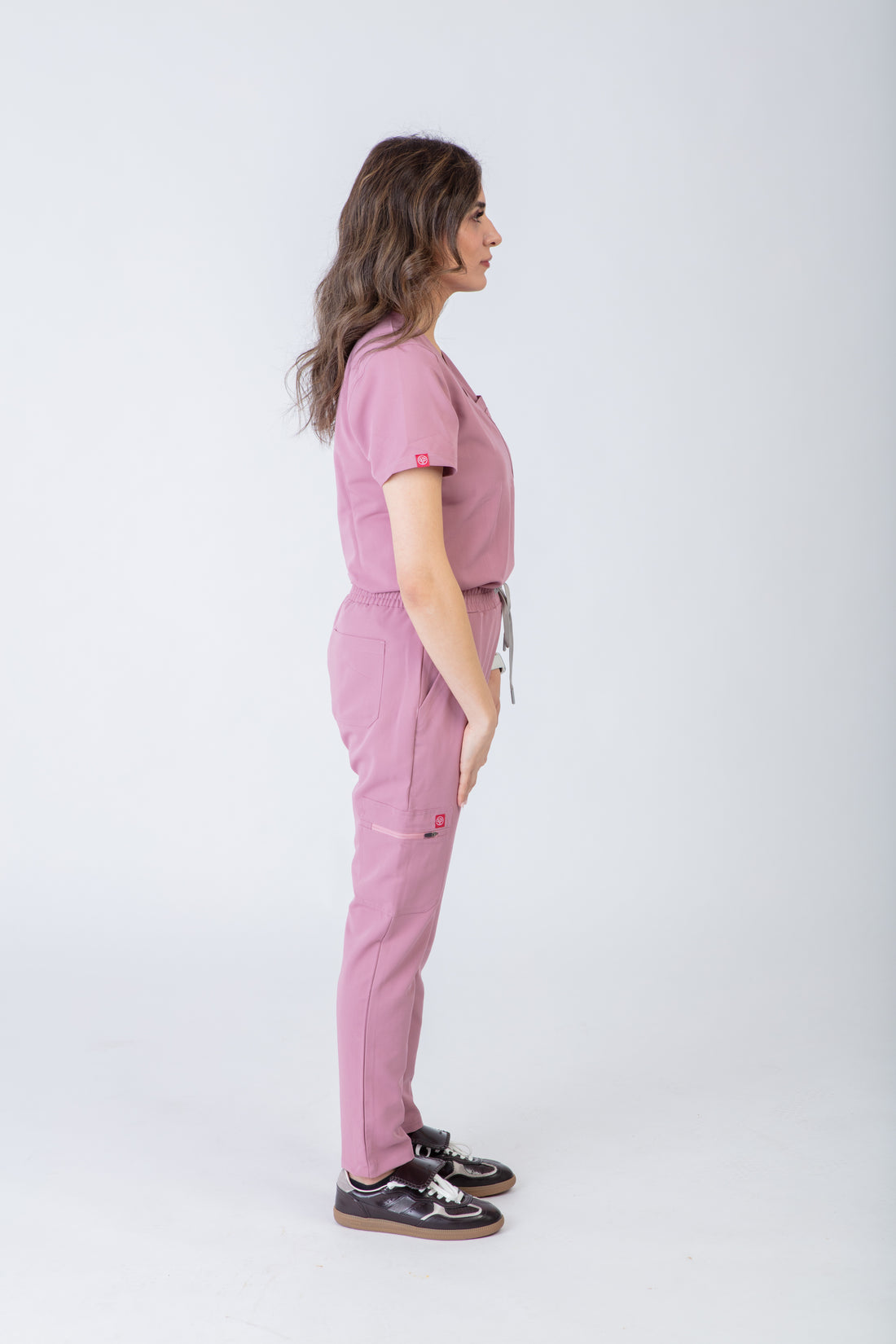 PAX Sequi women's pink straight-leg scrub trousers, side view on model