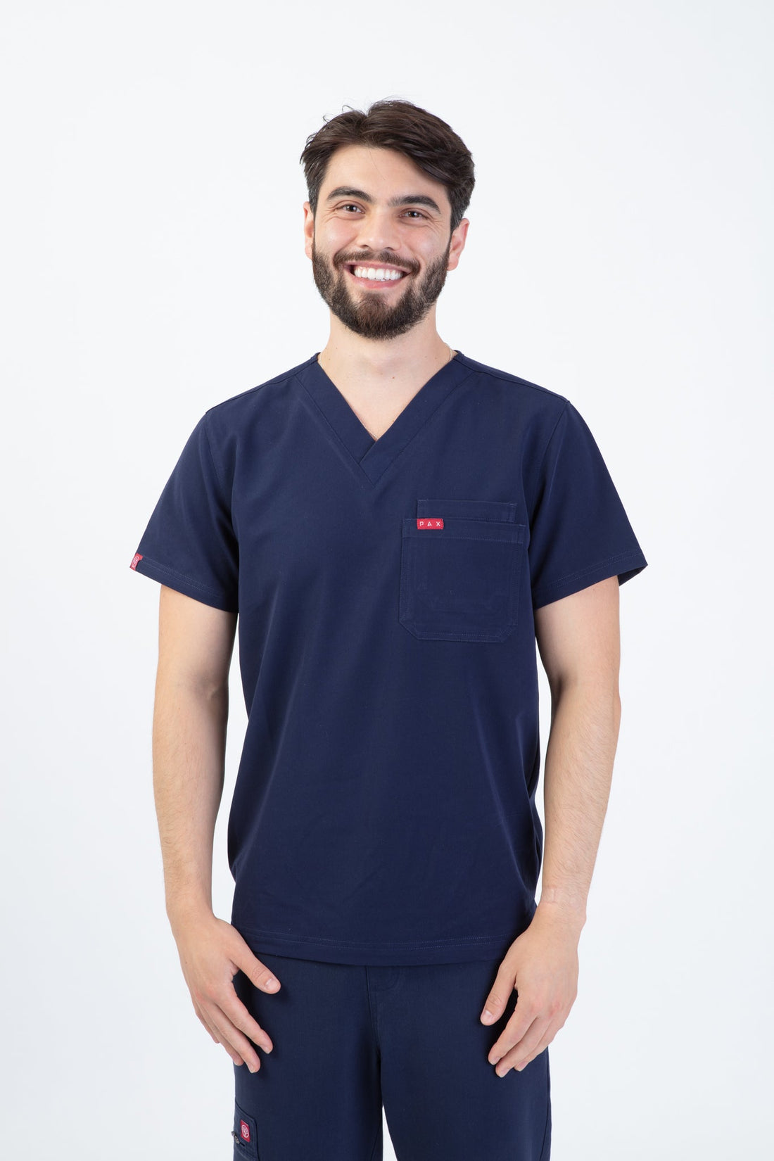 PAX Sequi men's navy scrub top, front view on model